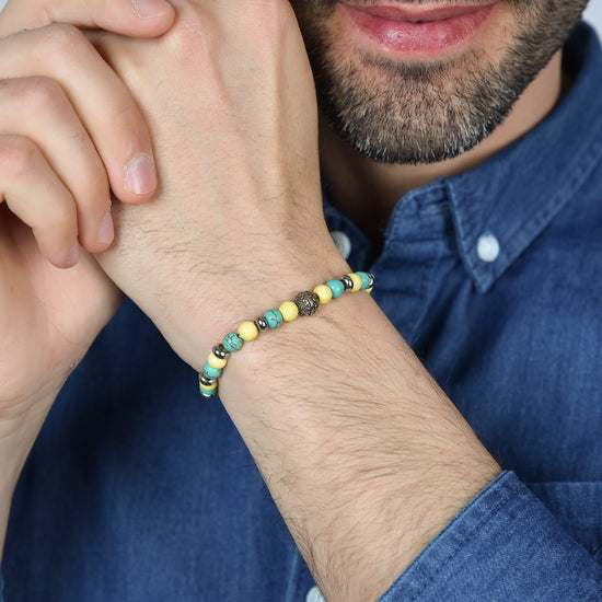 PULSERA ELÁSTICA DE HOMBRE CON PIEDRAS TURQUESAS Y AMARILLAS Y ELEMENTOS DE ACERO
