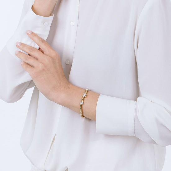 PULSERA DE ACERO DORADO CON MARIPOSA DE CRISTAL BLANCO