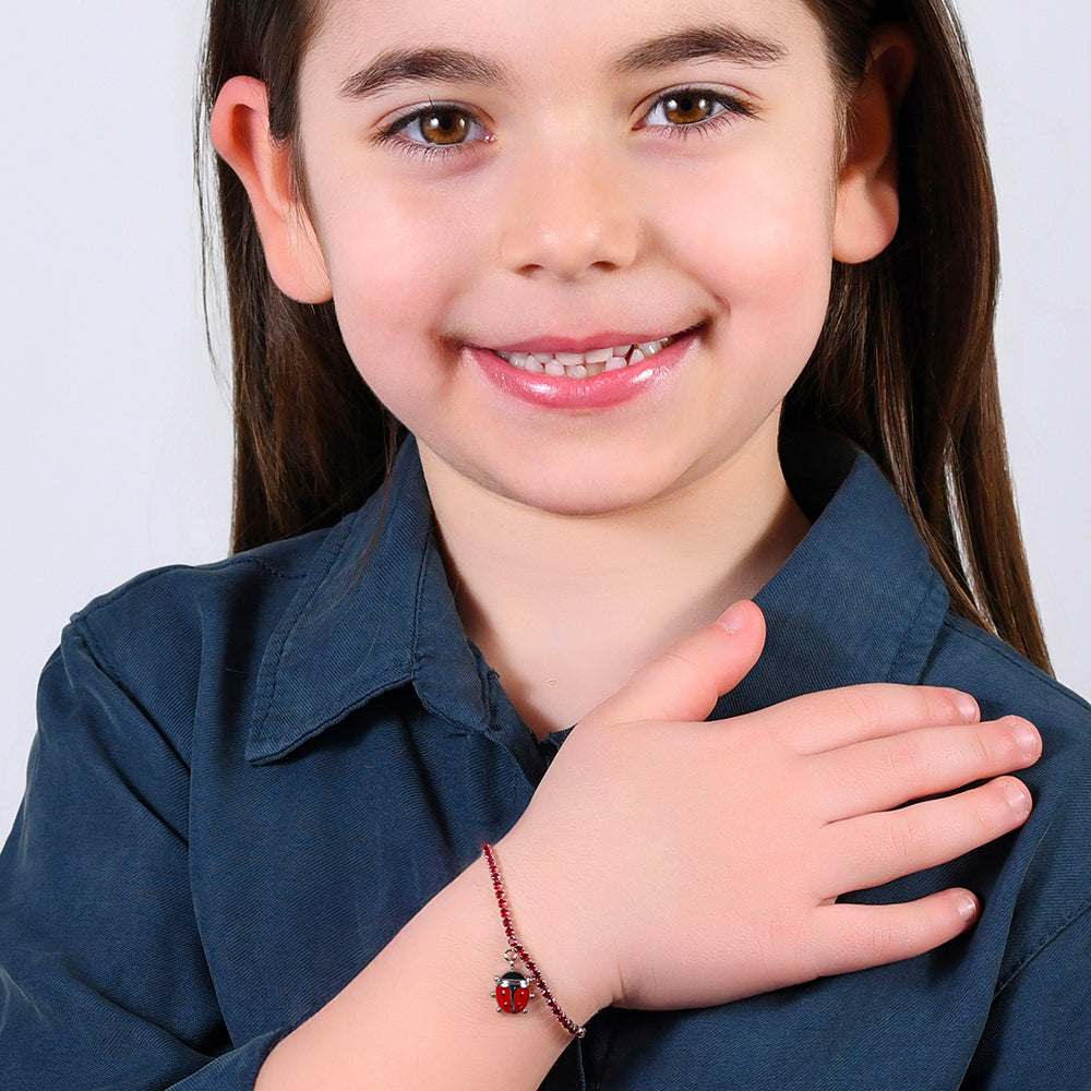 PULSERA DE TENIS DE ACERO PARA NIÑA CON CRISTALES ROJOS Y MARIQUITA