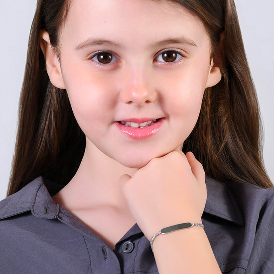 PULSERA DE TENIS DE NIÑA DE ACERO CON CRISTALES BLANCOS Y PLACA