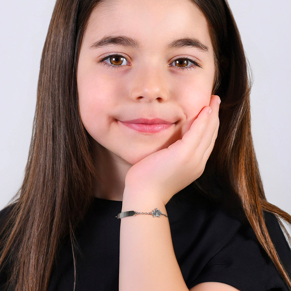 PULSERA DE NIÑA DE ACERO CON PLACA Y CORONA CON CRISTALES BLANCOS
