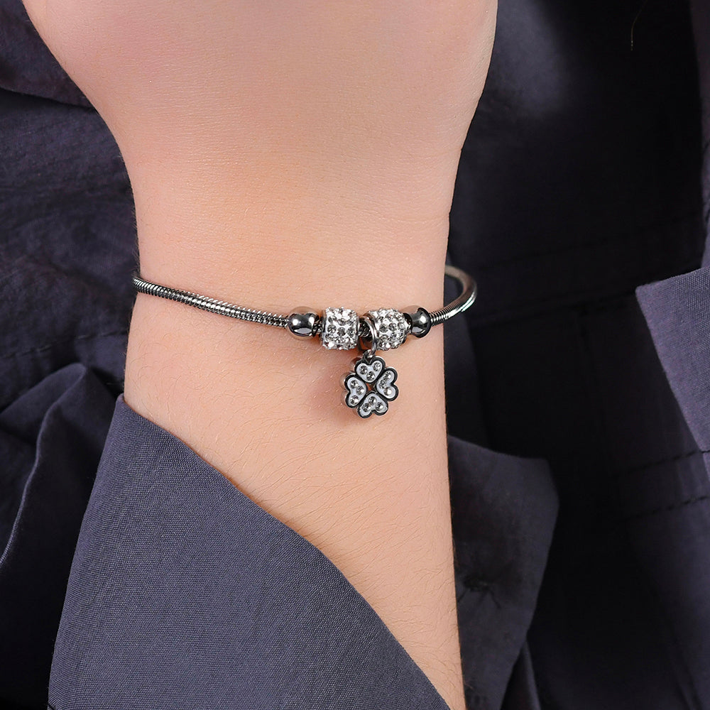 PULSERA DE ACERO PARA NIÑA CON TRÉBOL DE CUATRO HOJAS CON CRISTALES BLANCOS