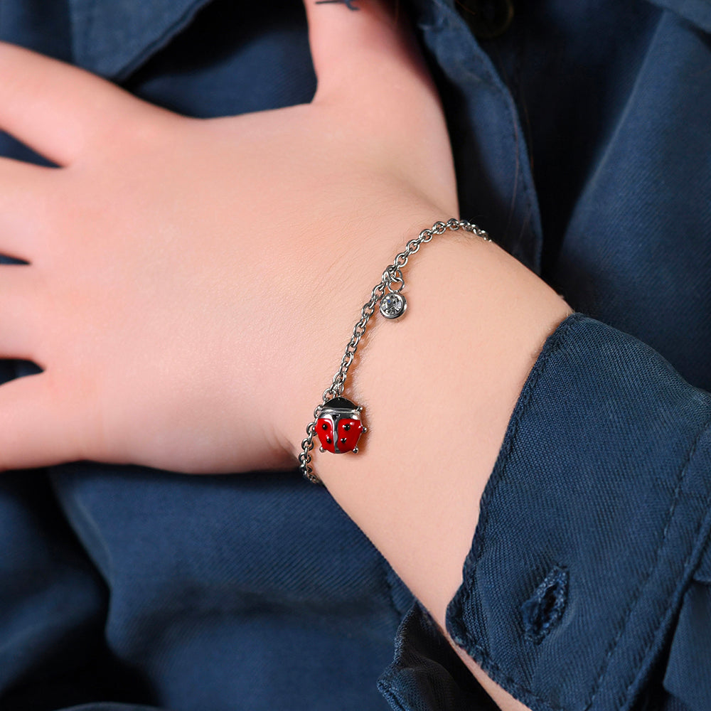 PULSERA DE ACERO PARA NIÑA CON MARIQUITA ESMALTADA EN ROJO Y NEGRO Y CRISTAL